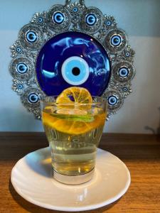 a glass of water with an orange on a plate at Donaire Hotel Boutique in Ajijic