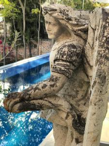 a statue of a woman standing next to a pool at Donaire Hotel Boutique in Ajijic