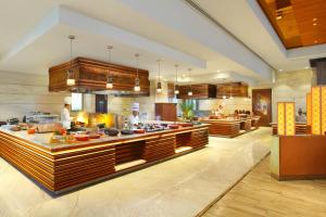 a kitchen with two chefs in a large kitchen at Seven Seas Hotel in New Delhi