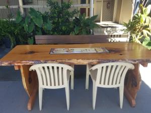 a wooden table with two white chairs around it at Bluff Hotel in Bluff +4 photos