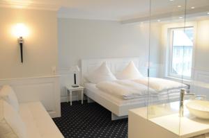 Postel nebo postele na pokoji v ubytování Boutique Hotel am Rathaus - Reblaus