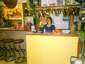 a woman sitting at a counter in a restaurant at Rock Inn Bailan in Ko Chang