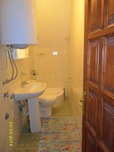 a bathroom with a sink and a toilet and a tub at Apartments Sara in Žabljak