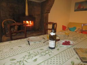 a bottle of wine sitting on top of a table at Manoir de Herclat in Néville-sur-Mer