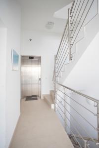 a hallway with stairs leading to a door at Apartments Lofiel in Novalja