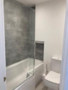 a bathroom with a tub and a toilet and a shower at Ouse View Cottage in Goole