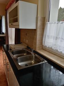 a kitchen with a sink and a microwave at All-Inn in Eger