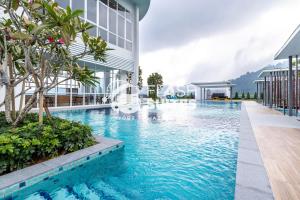 a swimming pool in front of a building at Windmill Upon Hills Premium Suites Genting Highland in Genting Highlands