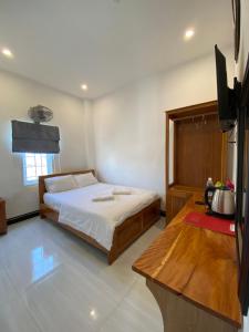 a bedroom with a bed and a television in it at Queen Hotel in Tuy Hoa
