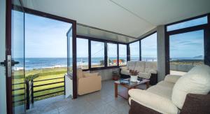 a living room with a view of the ocean at Casa da Vasca in Malpica