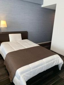 Uma cama ou camas num quarto em Sakura Shimanami Hotel