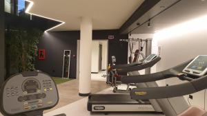 a gym with two tread machines and a treadmill at Elite Hotel Residence in Mestre