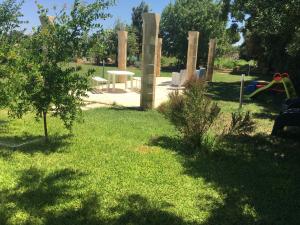 a park with a playground with a slide and a table at Masseria Nanni in Gallipoli