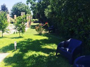 a yard with chairs and a playground in the grass at Masseria Nanni in Gallipoli