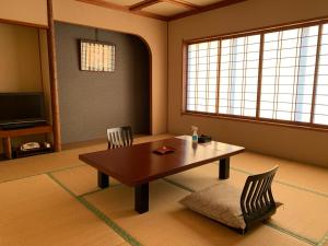 a living room with a table and two chairs at Premier Resort Yuga Ise Shima in Shima