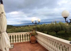 un balcón con una barandilla blanca y un jarrón de flores en Villa L'Anfora B&B, en Pianella