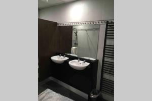a bathroom with two sinks and a mirror at The Loft @ Clifden Bay Apartments in Clifden +15 photos