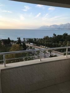 a balcony with a view of the ocean and mountains at Falez Uygulama Oteli in Antalya