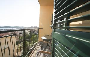 a balcony with two chairs and a view of the ocean at Apartmani Šarić in Šibenik