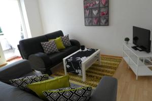 a living room with a couch and a table at Allgäutraum Ferienwohnung Nr 10 in Kempten