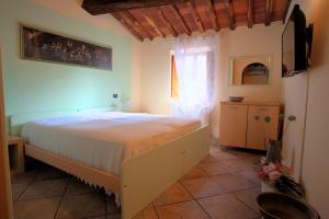 a bedroom with a large bed and a window at Arcobaleno Toscano in Pescia