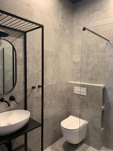 a bathroom with a toilet and a sink at Latarnia Wagabundy Bieszczady in Wola Michowa +89 photos