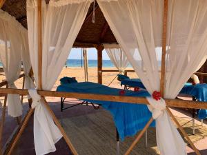 a group of beds in a tent on the beach at Nuweiba Club Resort in Nuweiba