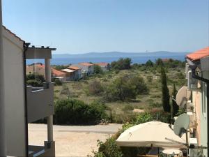 a view from the balcony of a house with an umbrella at Apartment Golden Sun in Vir