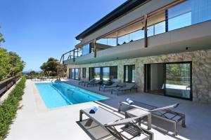 an exterior view of a house with a swimming pool at Villa Frangipani in Cape Town