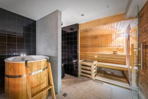 a bathroom with a tub and a shower at Willa Jarosta in Zakopane