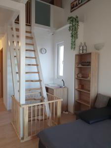 a living room with a spiral staircase and a desk at Apartment Golden Sun in Vir
