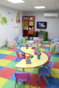 a classroom with two tables and chairs and a tv at Nuweiba Club Resort in Nuweiba