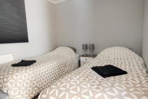 - 2 lits installés l'un à côté de l'autre dans une chambre dans l'établissement Chalet Op De Veluwe # Eiken, à Putten
