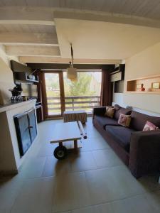 a living room with a couch and a table at Espacio Catedral in San Carlos de Bariloche