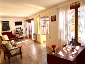 a living room with a couch and a table in a room at Hostel Elal in El Calafate