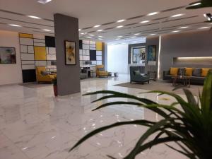 a lobby with couches and chairs in a building at Executive Suites in Riyadh