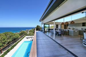an outdoor deck with a view of the ocean at Villa Frangipani in Cape Town