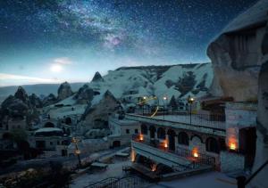 a night view of a mountain with a starry sky at Elite Cave Suites in Goreme