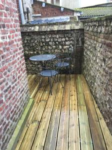a table and chairs sitting on a wooden deck at Chambre D'hôte Villa Maurice in Étretat