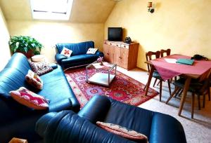 a living room with a blue couch and a table at Gasthaus Pflug 