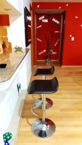 two bar stools in a kitchen with a red wall at Castillo de Chapultepec in Mexico City