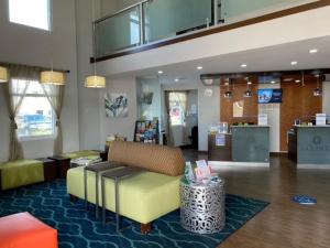 a lobby with a couch and a table in a store at La Quinta by Wyndham Oceanfront Daytona Beach in Daytona Beach