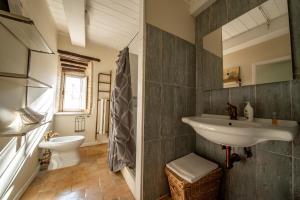 a bathroom with a sink and a toilet at Da Bacchetta in Assisi +37 photos