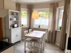 a kitchen and dining room with a table and chairs at Ferienwohnung Kraft in Clausthal-Zellerfeld