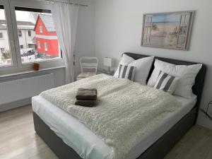 a bedroom with a bed with a blanket and a window at Pension Unikum Waldheim in Waldheim