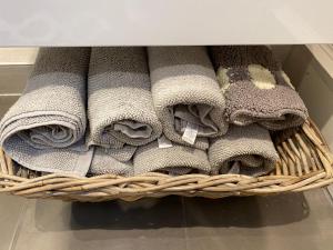 a bunch of towels in a basket in a drawer at The Nook Devon Square in Kingsbridge
