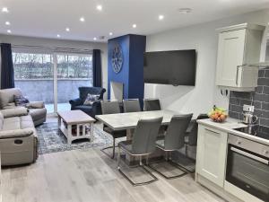 a kitchen and living room with a table and chairs at Cranfield Cottage by the Sea 4 star NITB approved in Kilkeel
