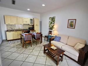 a living room with a couch and a table at Fuori Rotta Holiday Home in Maruggio