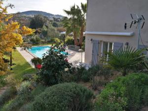 a view of a house and a swimming pool at studio 5min plage agosta in Albitreccia