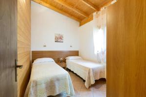 a bedroom with two beds and a window at Agriturismo Alimini a Otranto in Otranto